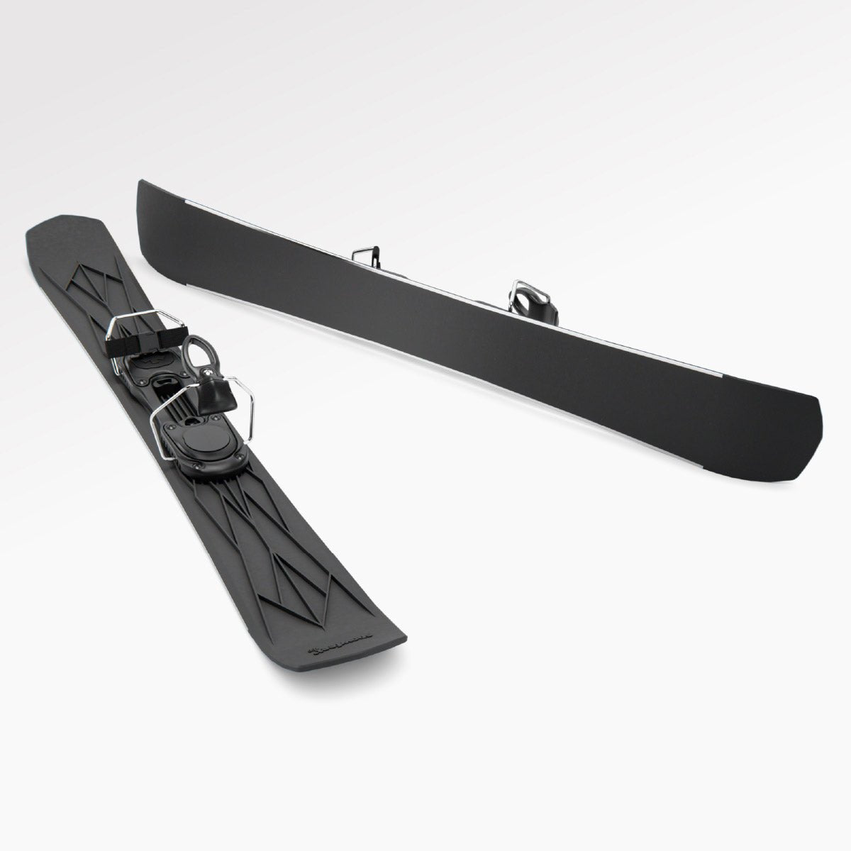 Skiblades Pair of black short skis Snowfeet with ski bindings on a white background