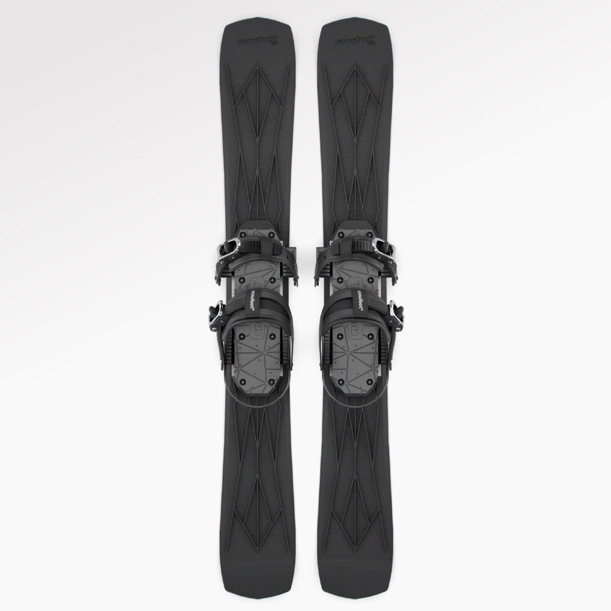 Skiblades Pair of black short skis Snowfeet with snowboard bindings on a white background
