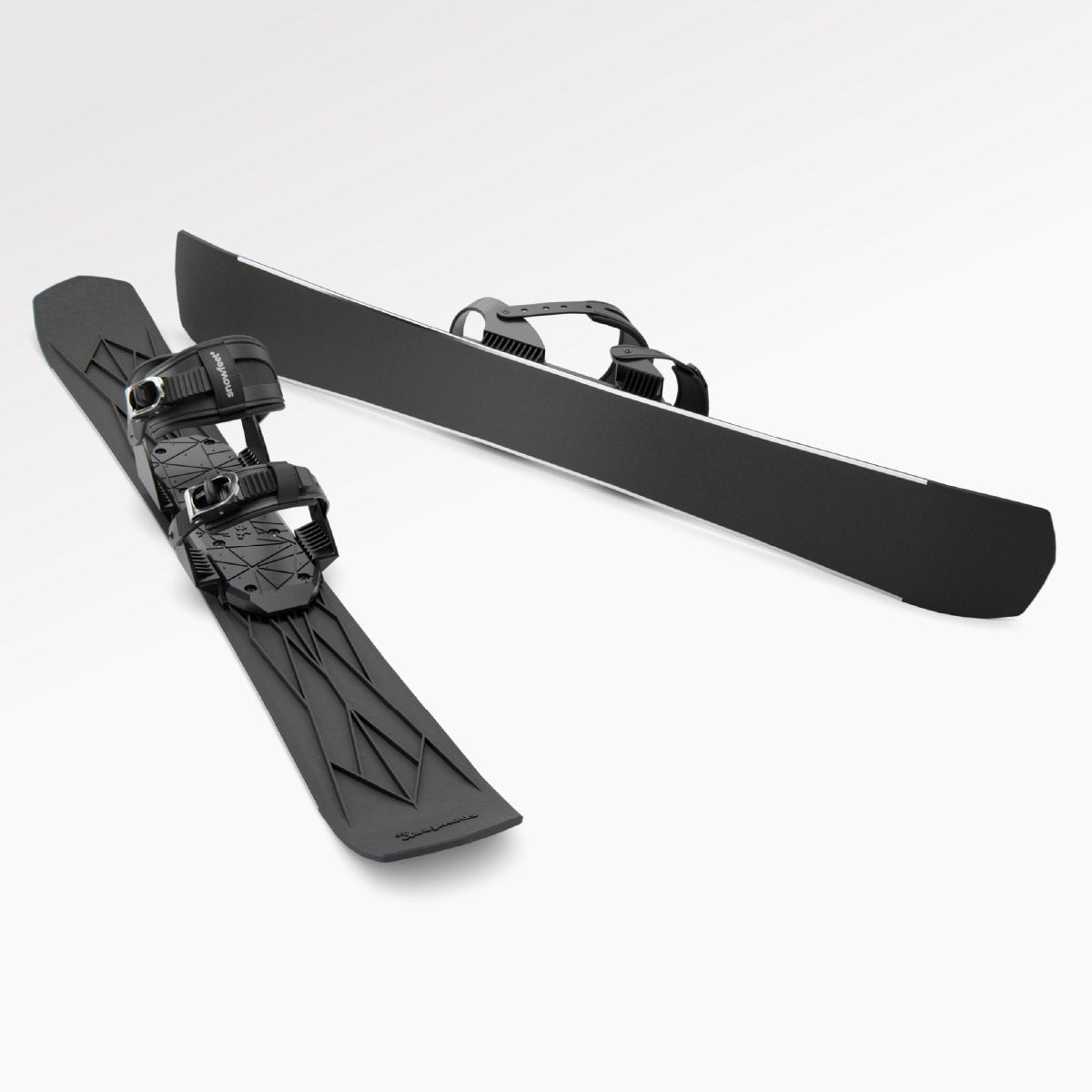 Skiblades Pair of black short skis Snowfeet with snowboard bindings on a white background