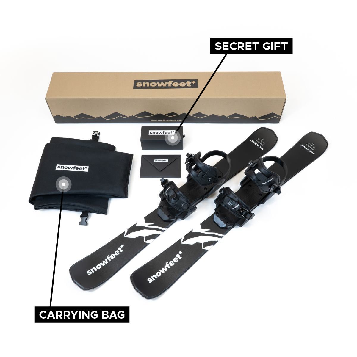 Black snowboard with bindings, carrying bag, and 'snowfeet' branded box on a white background