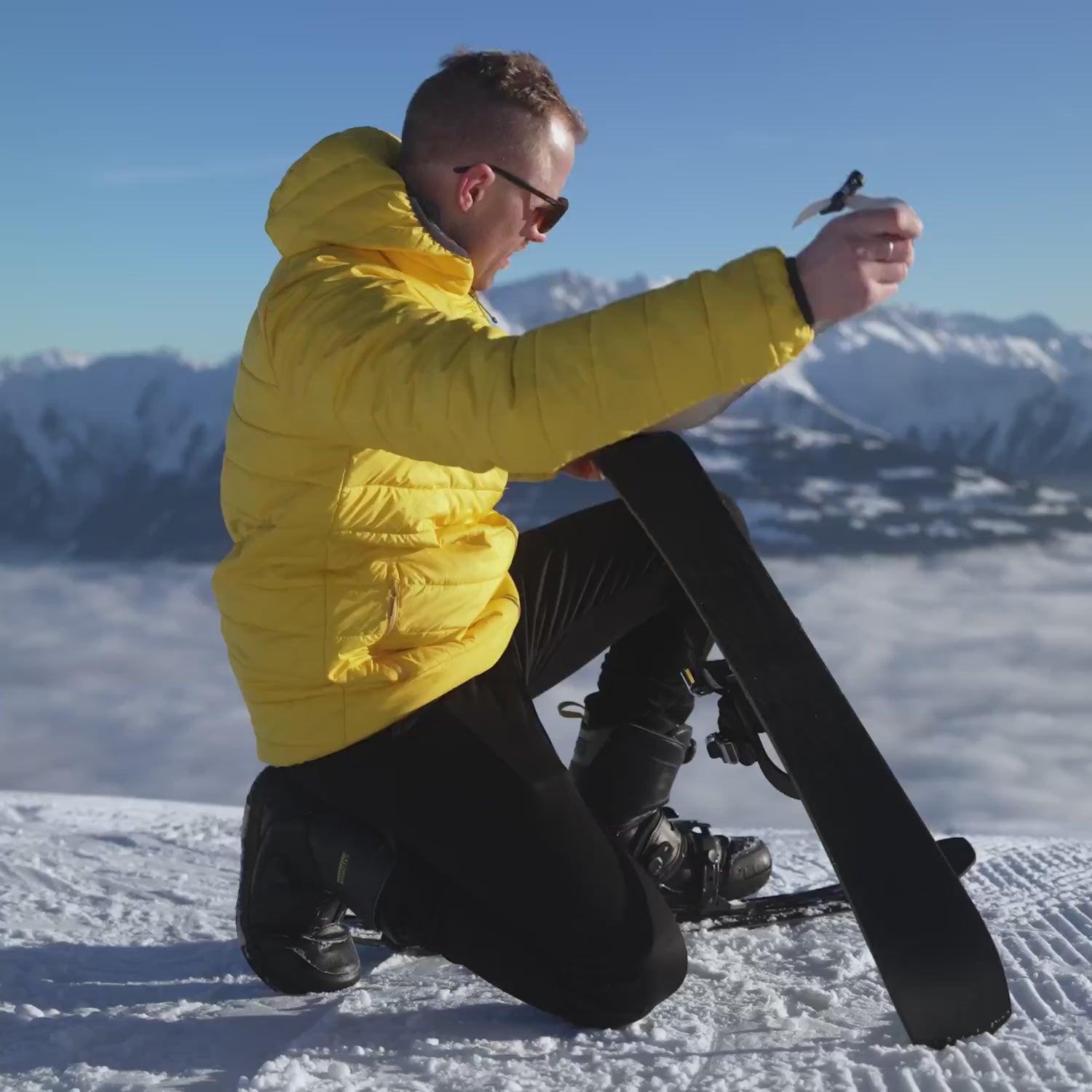 Men with yellow jacket using Snowfeet Walkski on the mountains